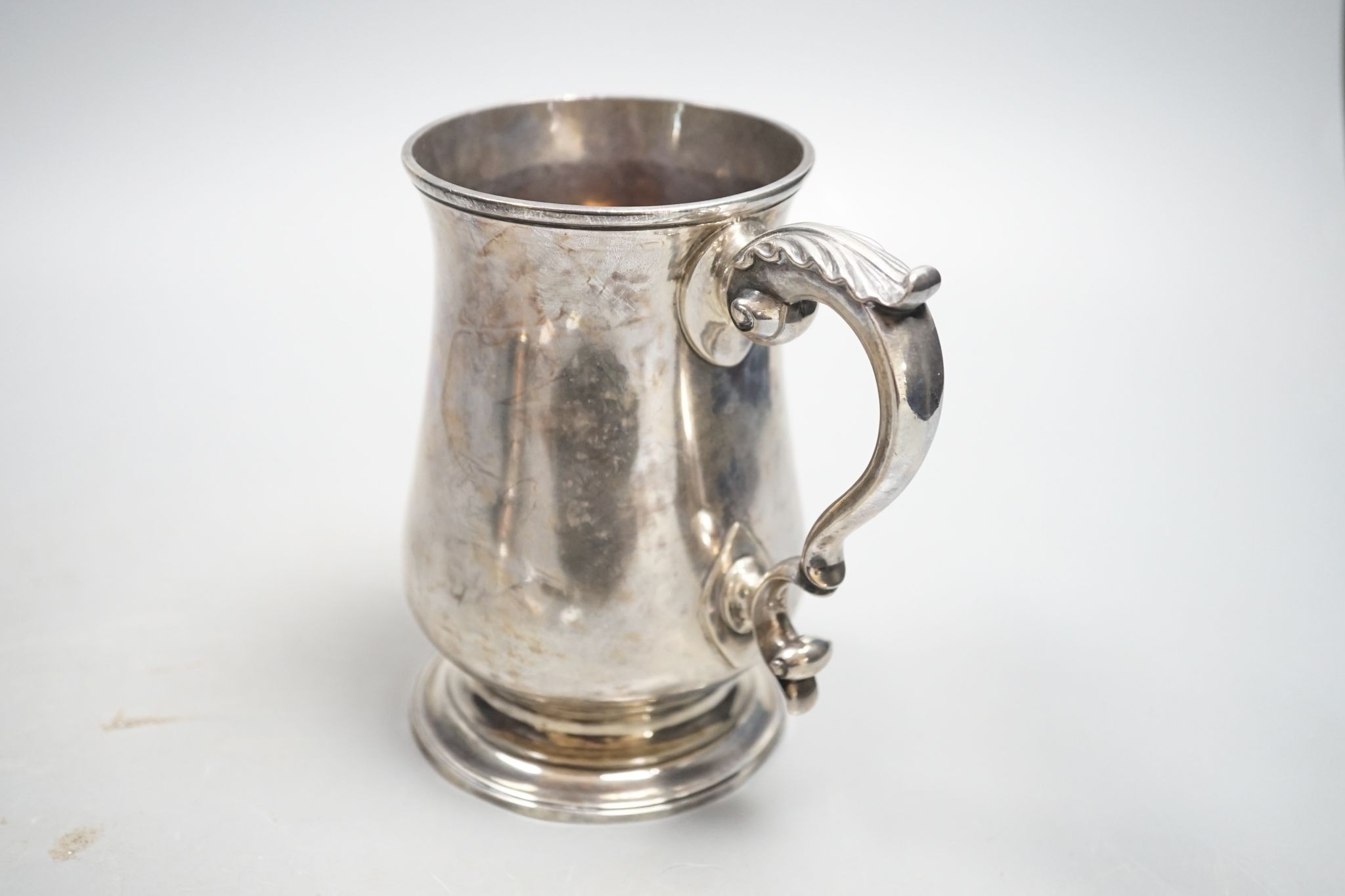 A George III silver baluster mug, with later engraved monogram, John Chapman II, London, 1773, 13.6cm, 14oz.